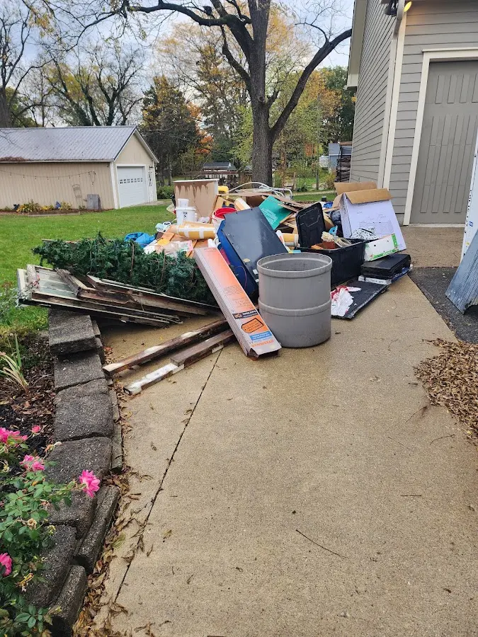 Dumpster being loaded with debris for Estate Cleanout Dumpster Rental in Williamstown